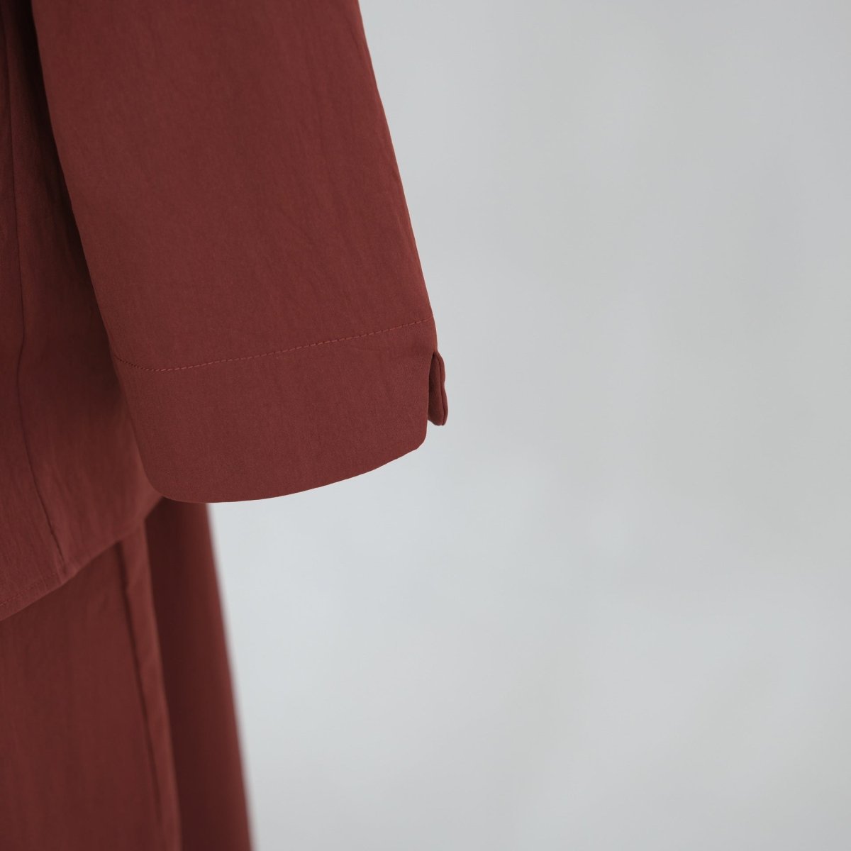 Adjustable back waist cord detail on button-front longline top