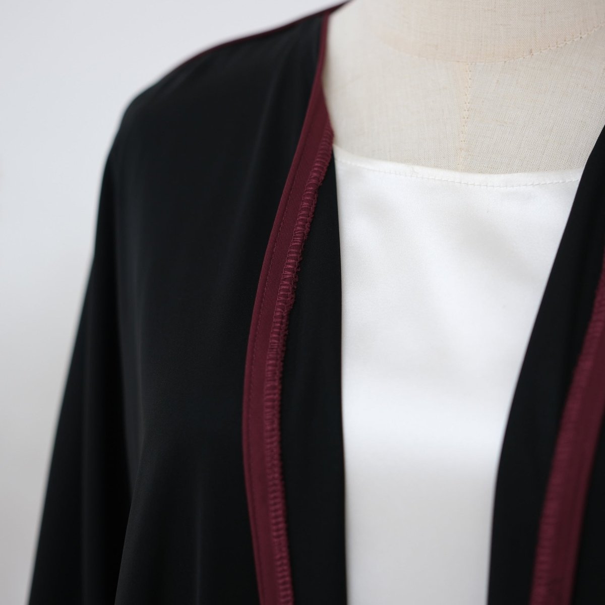 Structured yet fluid nida abaya drape shown from front angle
