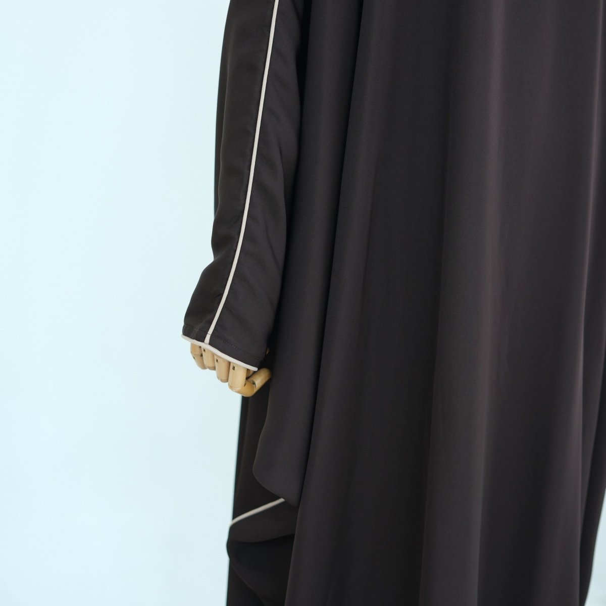 Tonal piping trim detail on front panel of third colourway batwing abaya