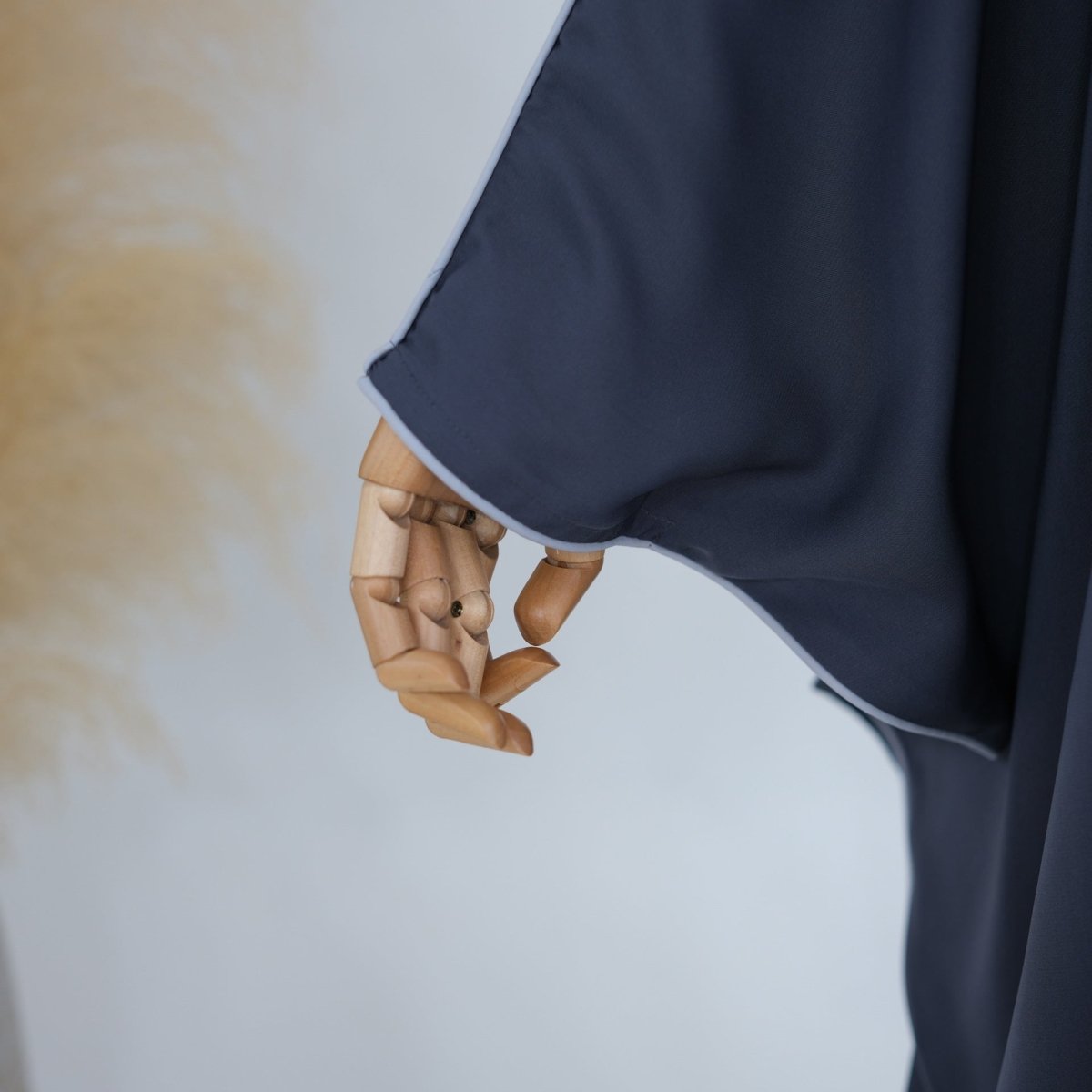 Back view of contrast piped abaya showing clean unfitted silhouette