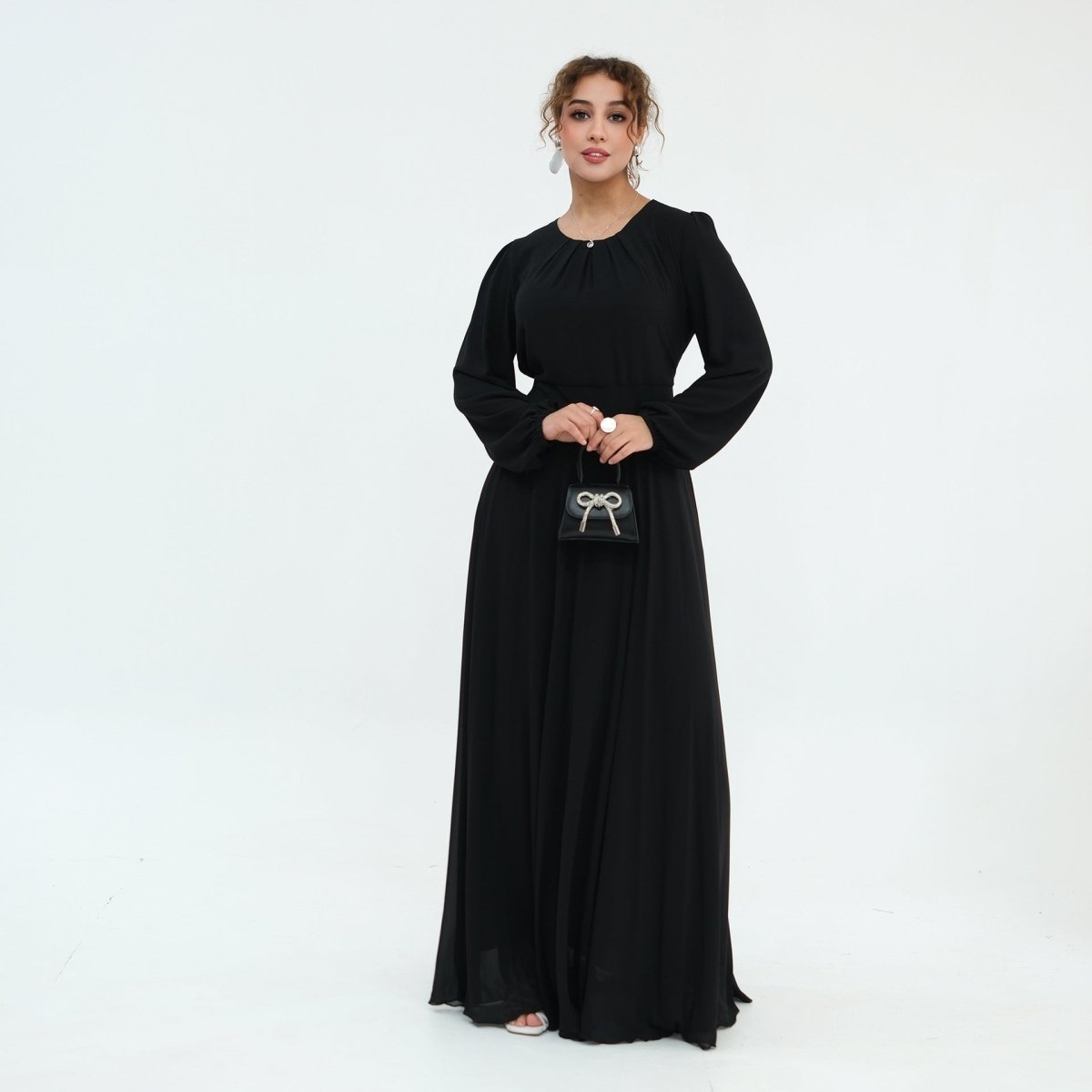 Three-quarter view of crystal embellished cape overlay on chiffon maxi dress
