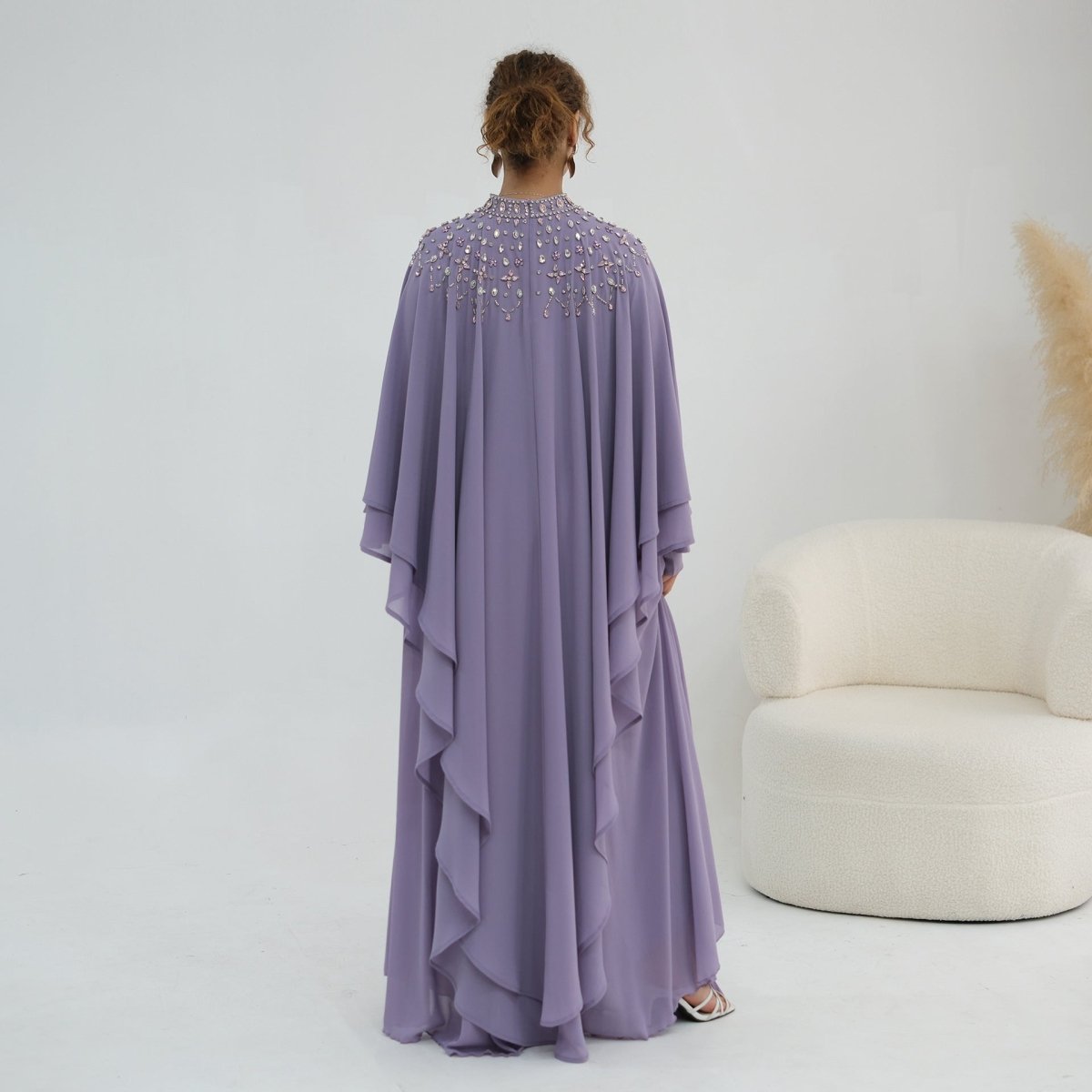 Draped batwing cape sleeves in motion on lightweight chiffon fabric