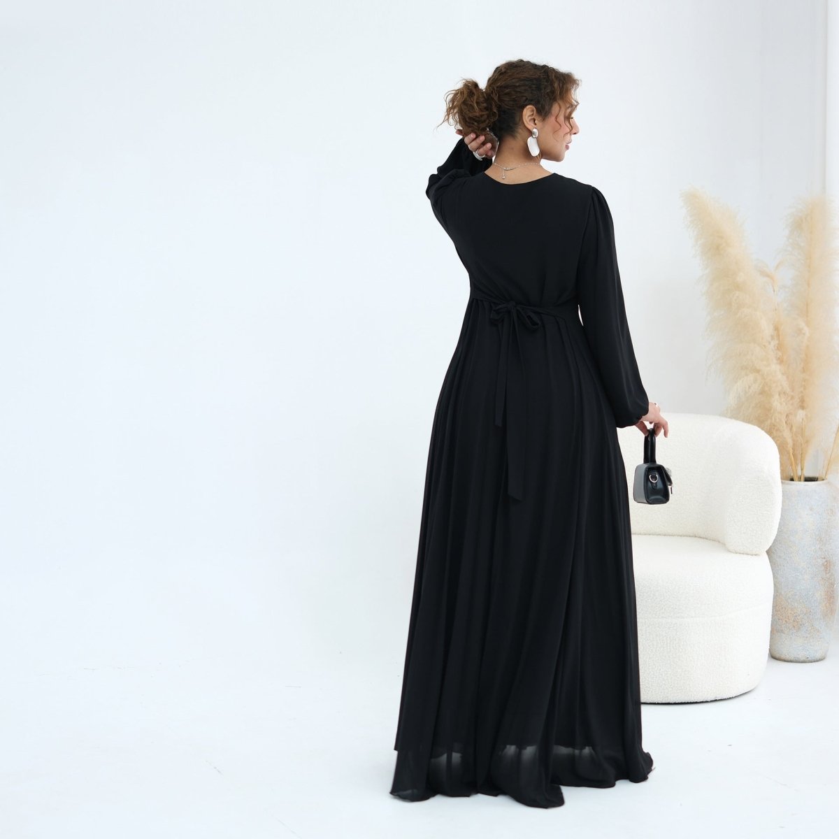 Cape overlay worn open showing inner dress round neckline and fitted silhouette