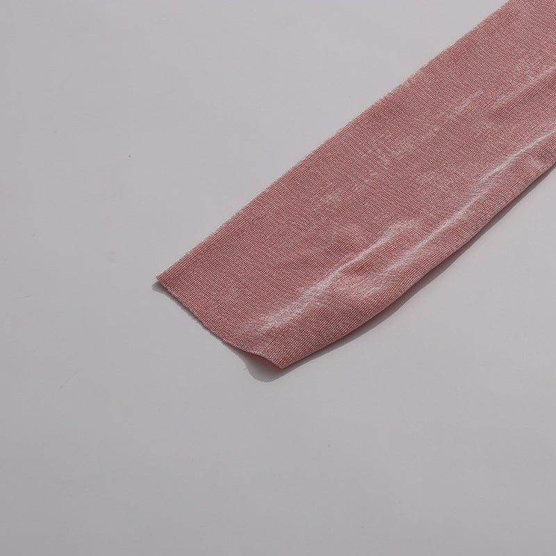 Detail of concealed snap button at collar anchoring the diagonal ruche at the neckline