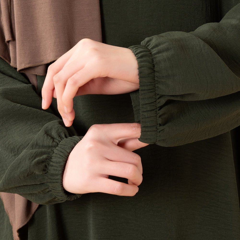 Three-quarter view of modest crepe maxi dress with pockets