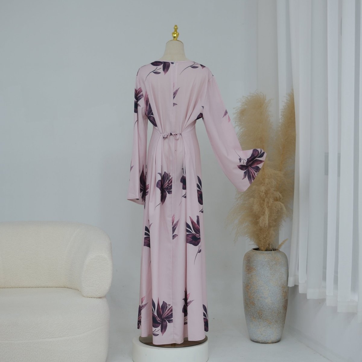 Self-tie sash at back waist cinching the floral maxi for a defined silhouette