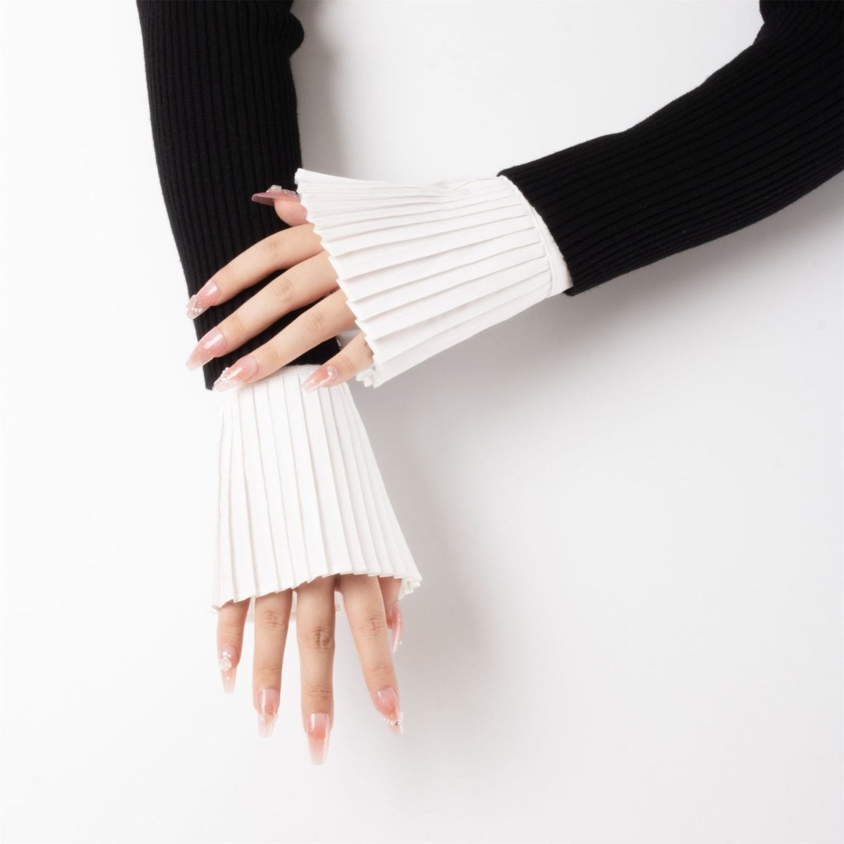 White french pleated cuff sleeves with dramatic texture and volume