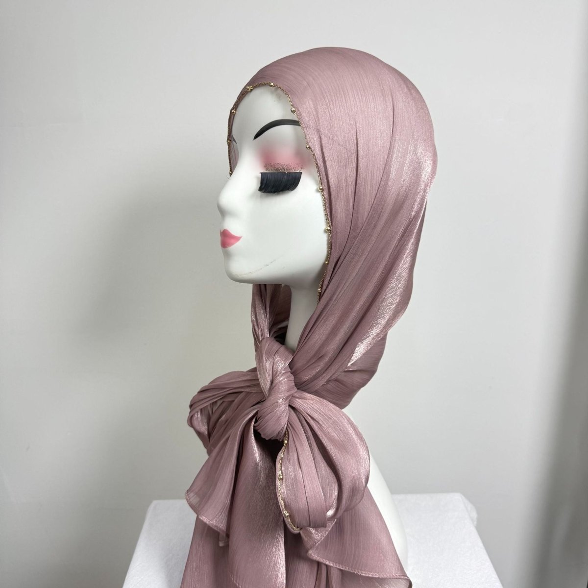 Gold chain trim detail on crinkle satin hijab — close macro view