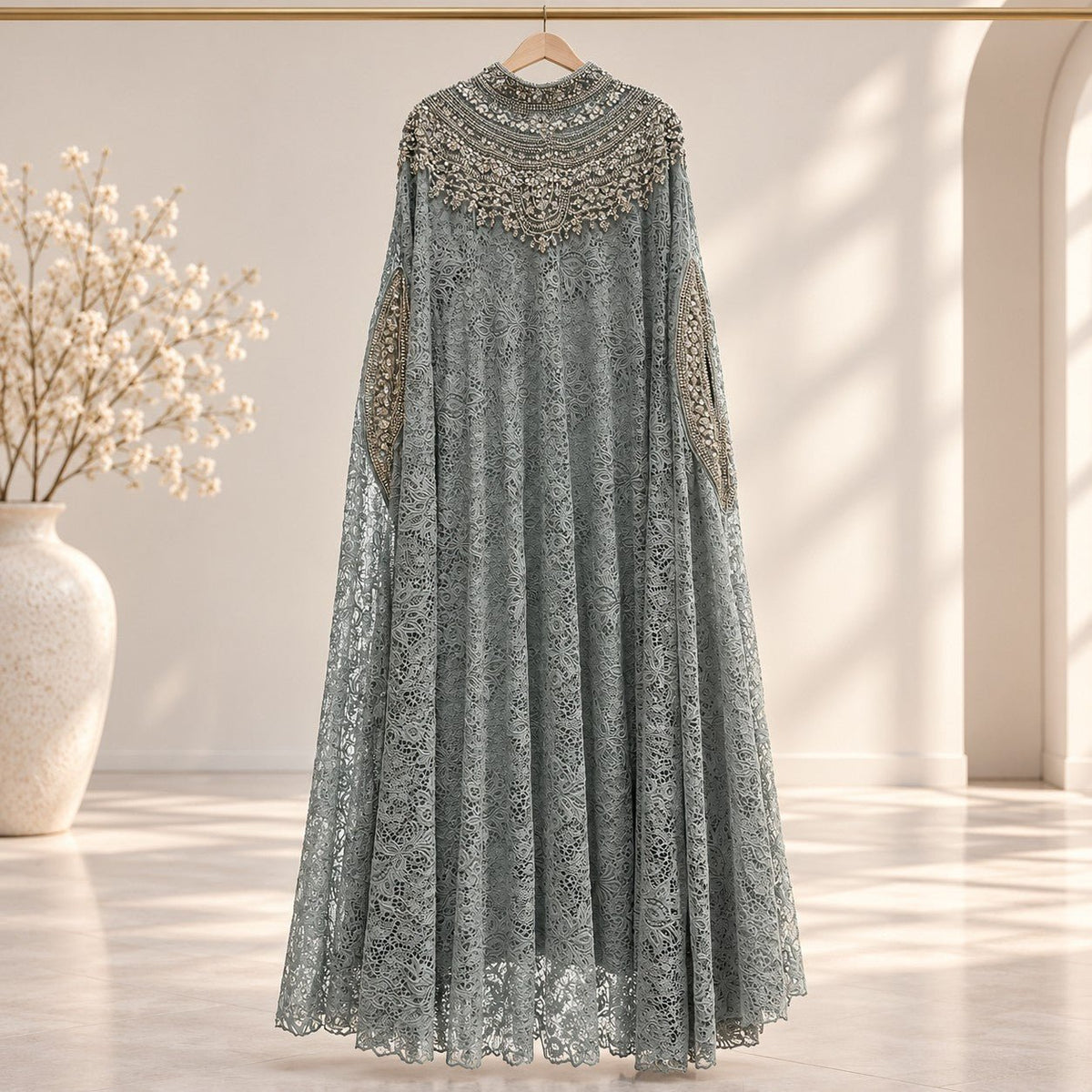 Full-length front view of crochet lace overlay abaya top set in cream