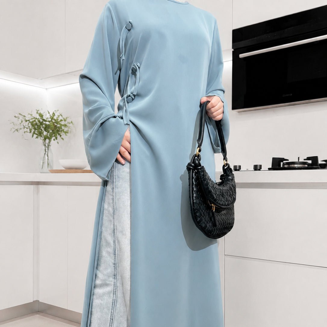 Modest Nida longline tunic top styled over wide-leg trousers, front angle
