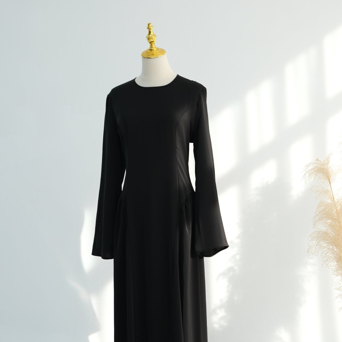Rear three-quarter view of nida bell sleeve abaya dress