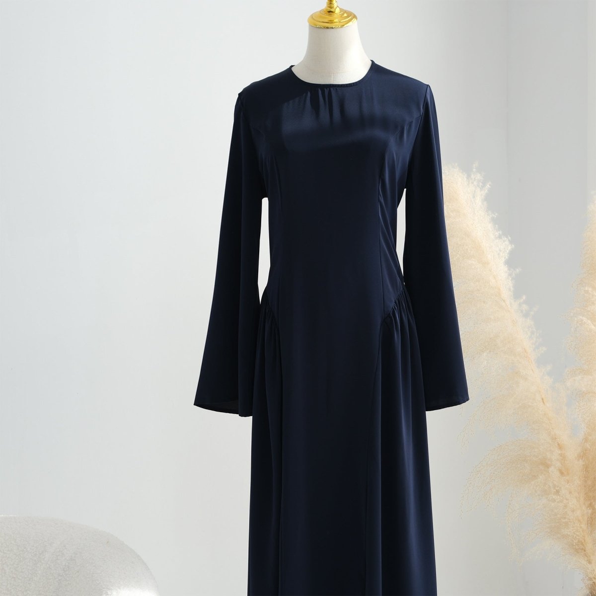 Three-quarter view of nida maxi dress highlighting A-line skirt volume