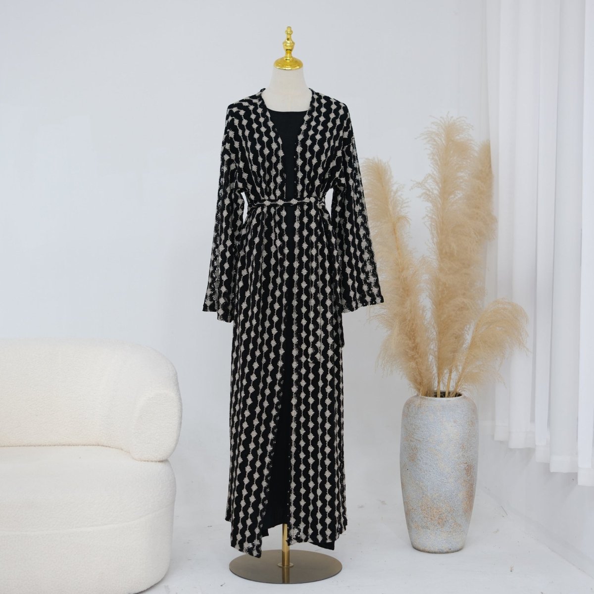 Draped sleeve detail of openwork lace knit abaya