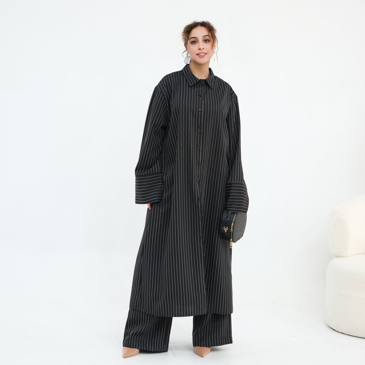 Front view of longline oversized pinstripe shirt with spread collar