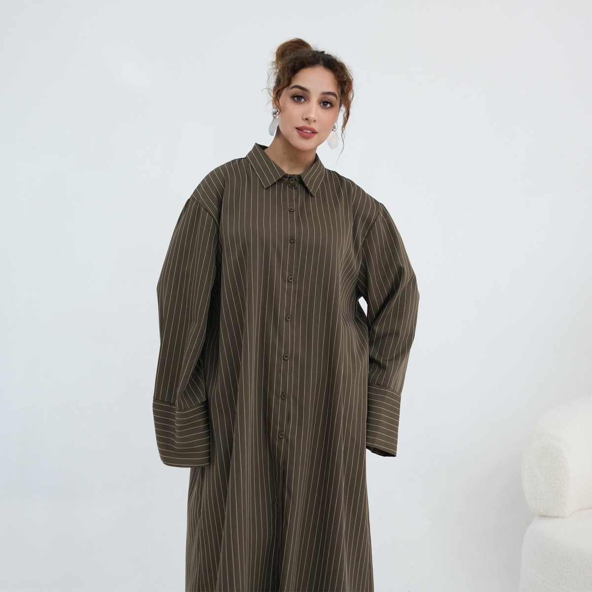 Back view of longline oversized pinstripe shirt falling below the knee