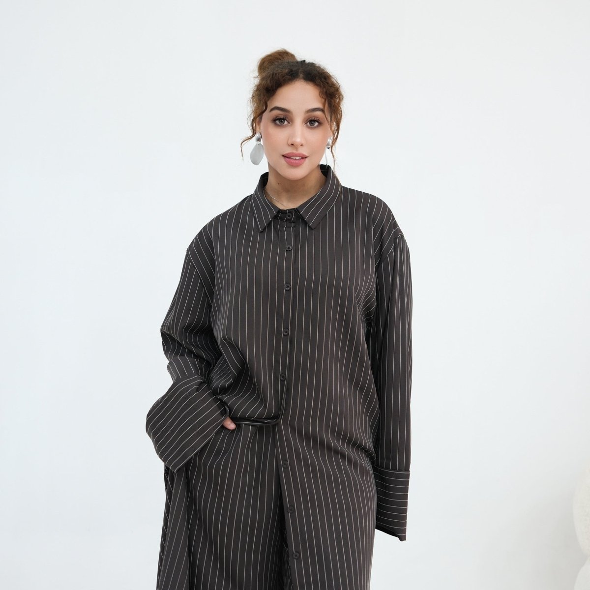 Full outfit flat lay of pinstripe longline shirt and wide-leg trousers