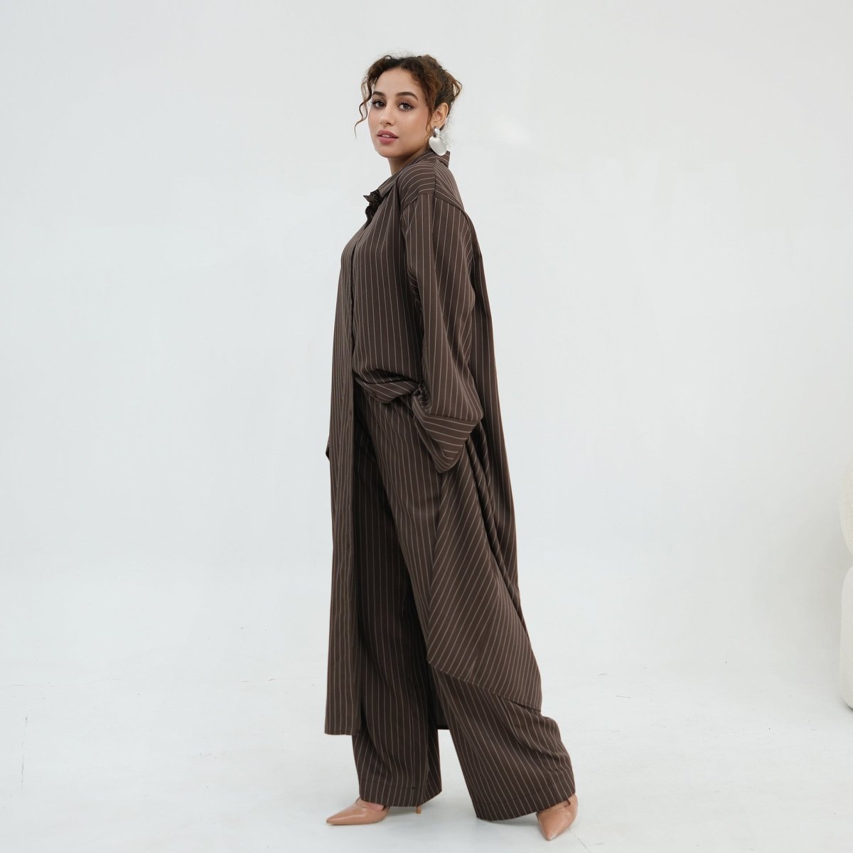 Three-quarter view of the pinstripe modest shirt suit set in motion