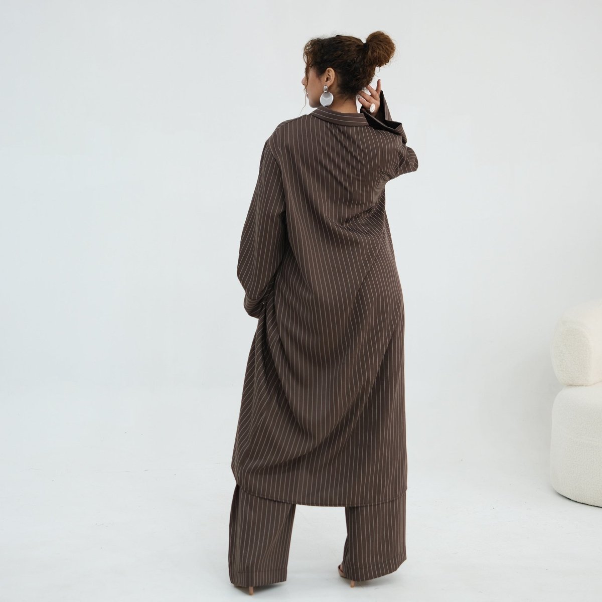Elasticated waistband close-up on the wide-leg pinstripe trousers