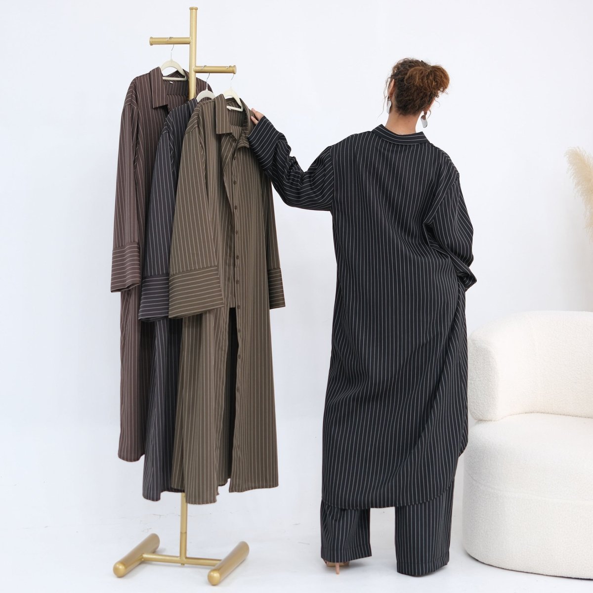 Full-length side view of pinstripe shirt and wide-leg trouser set