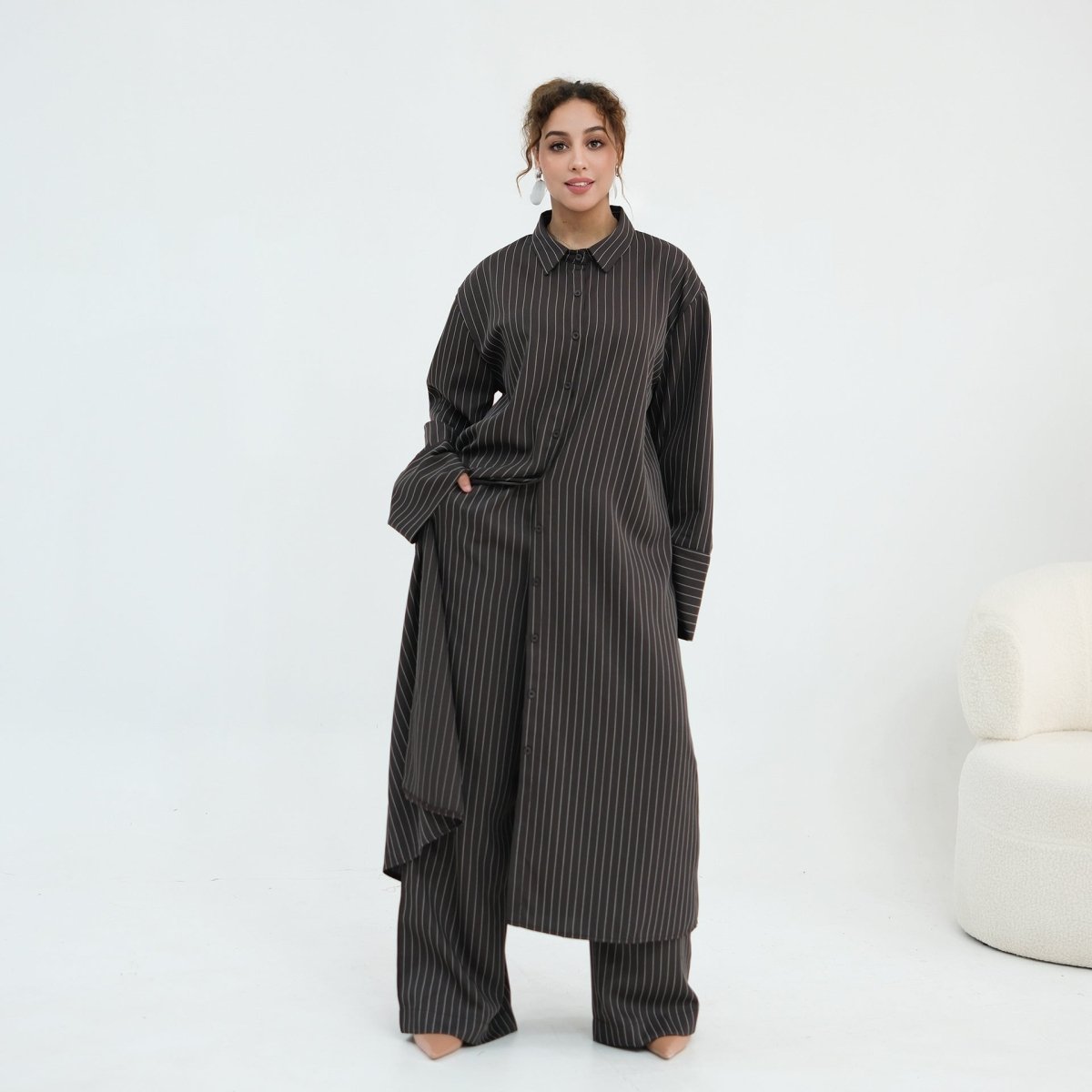 Pinstripe oversized shirt layered open over matching wide-leg trousers