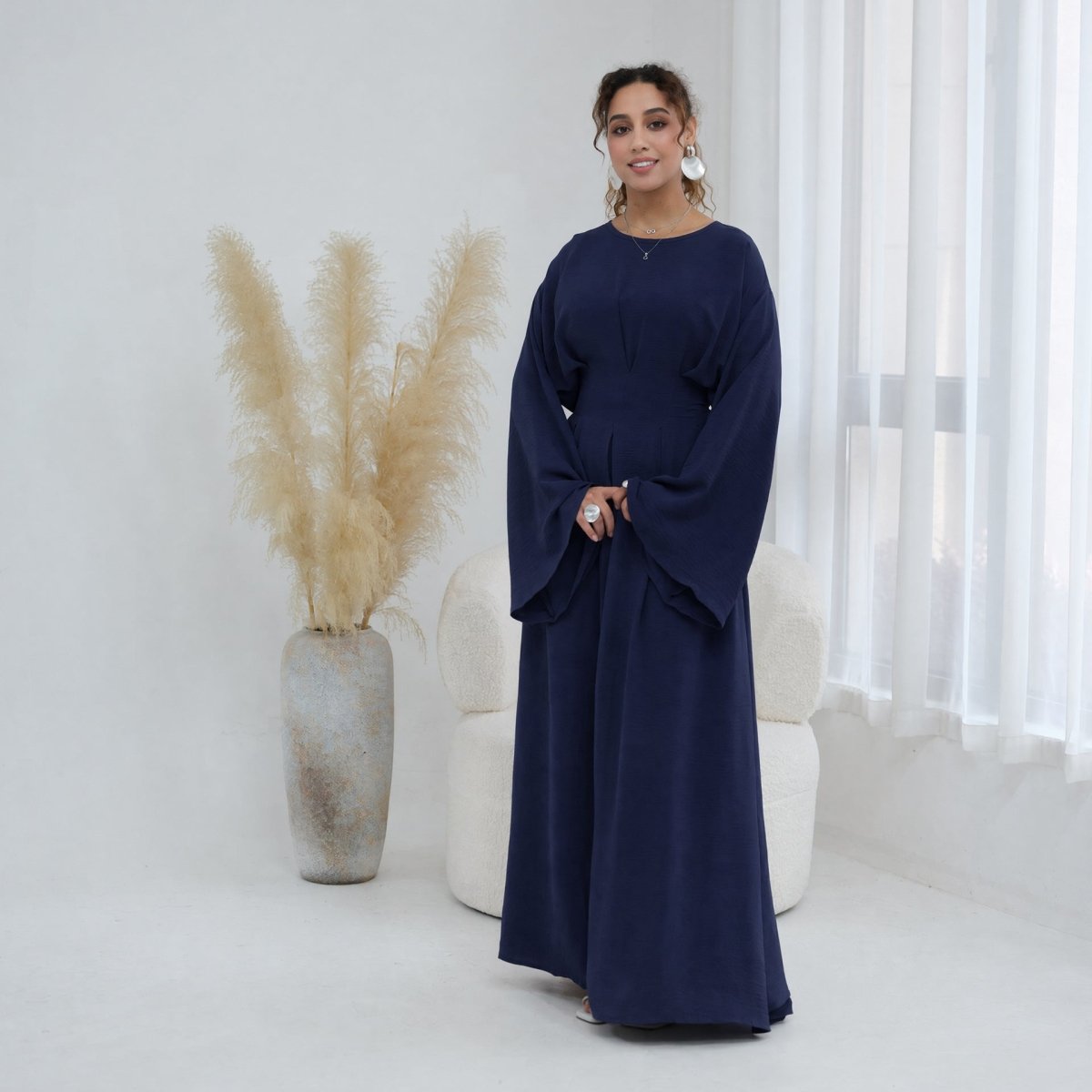 Flowing A-line skirt hem on full-length crinkle maxi dress