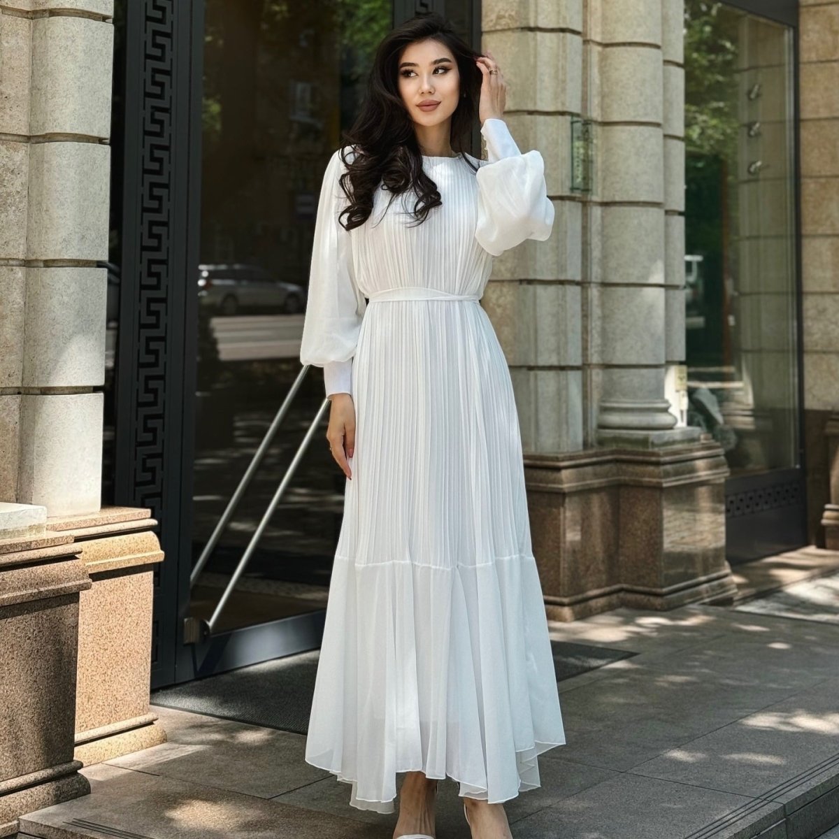 Full skirt movement of pleated tiered maxi dress from ground level