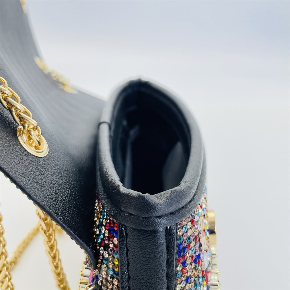 Light-reflecting rhinestones on luxury clutch bag