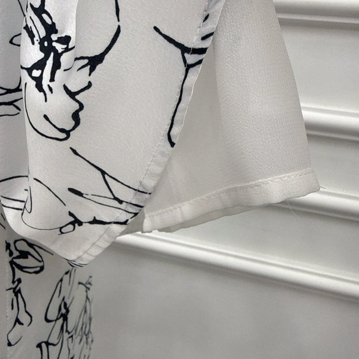 Full-length front view of mini heart print abaya and hijab set in black on white