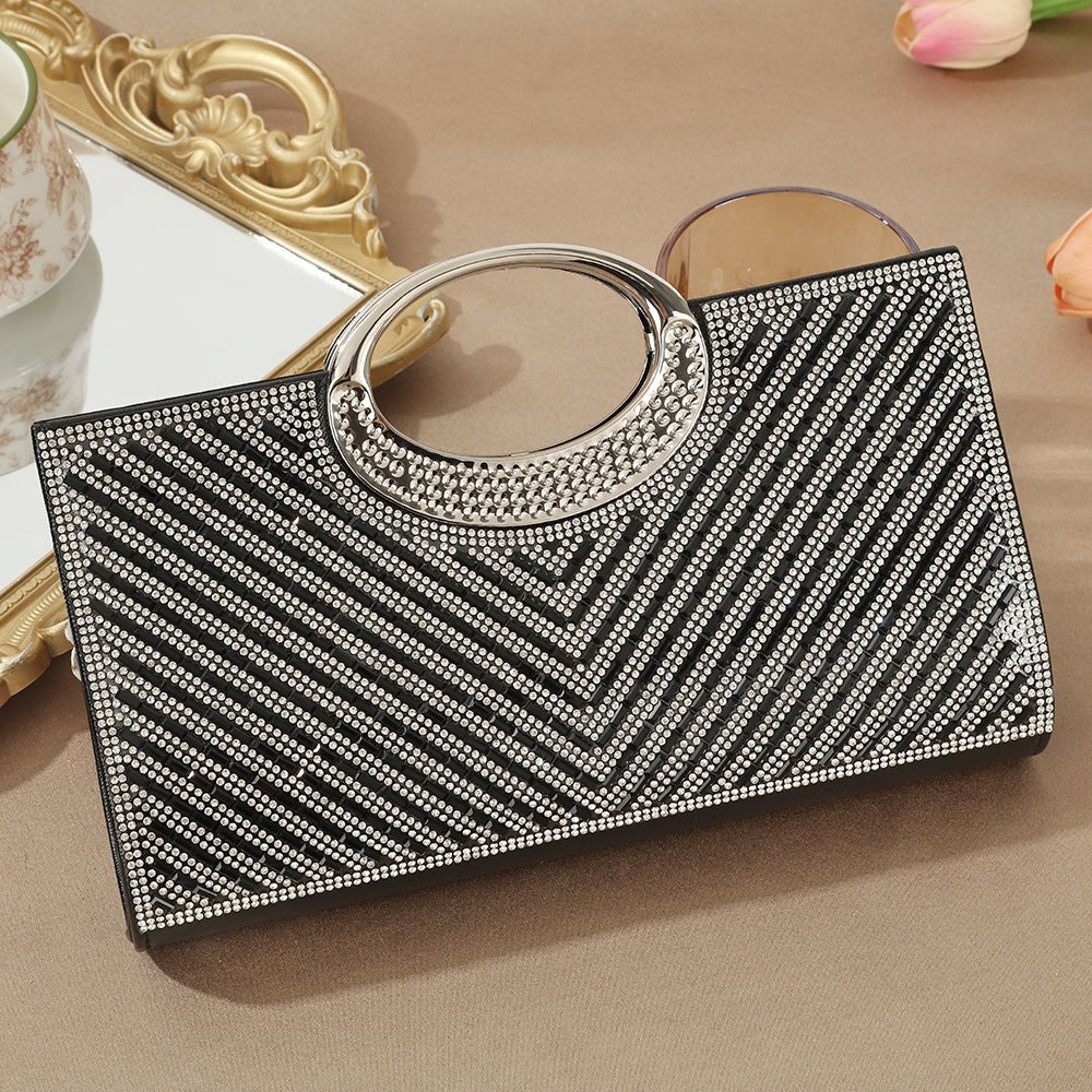 Vintage circular handle clutch bag resting on luxury gift box packaging
