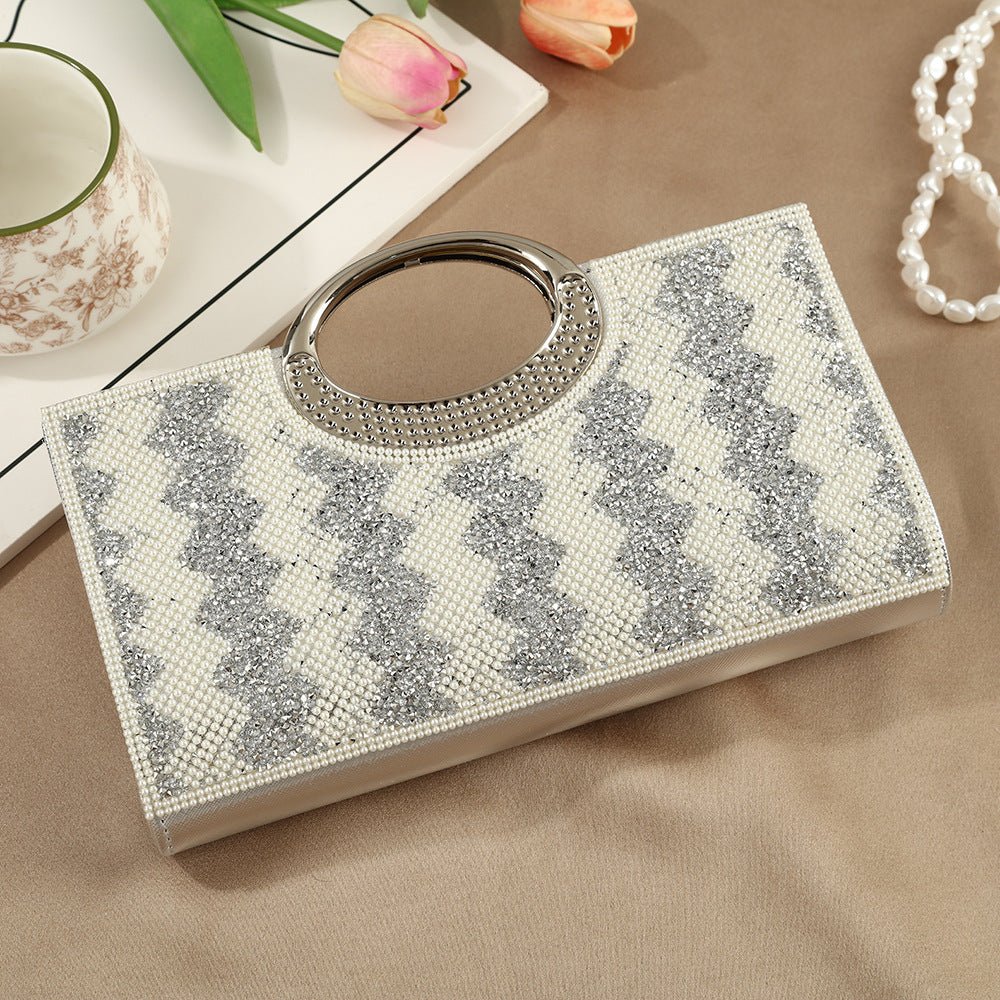 Rhinestone sparkly clutch bag styled on top of folded abaya fabric