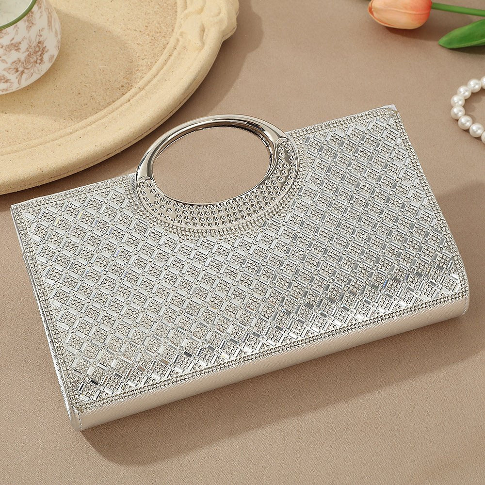 Vintage circular handle clutch bag in black-tone hardware laid flat