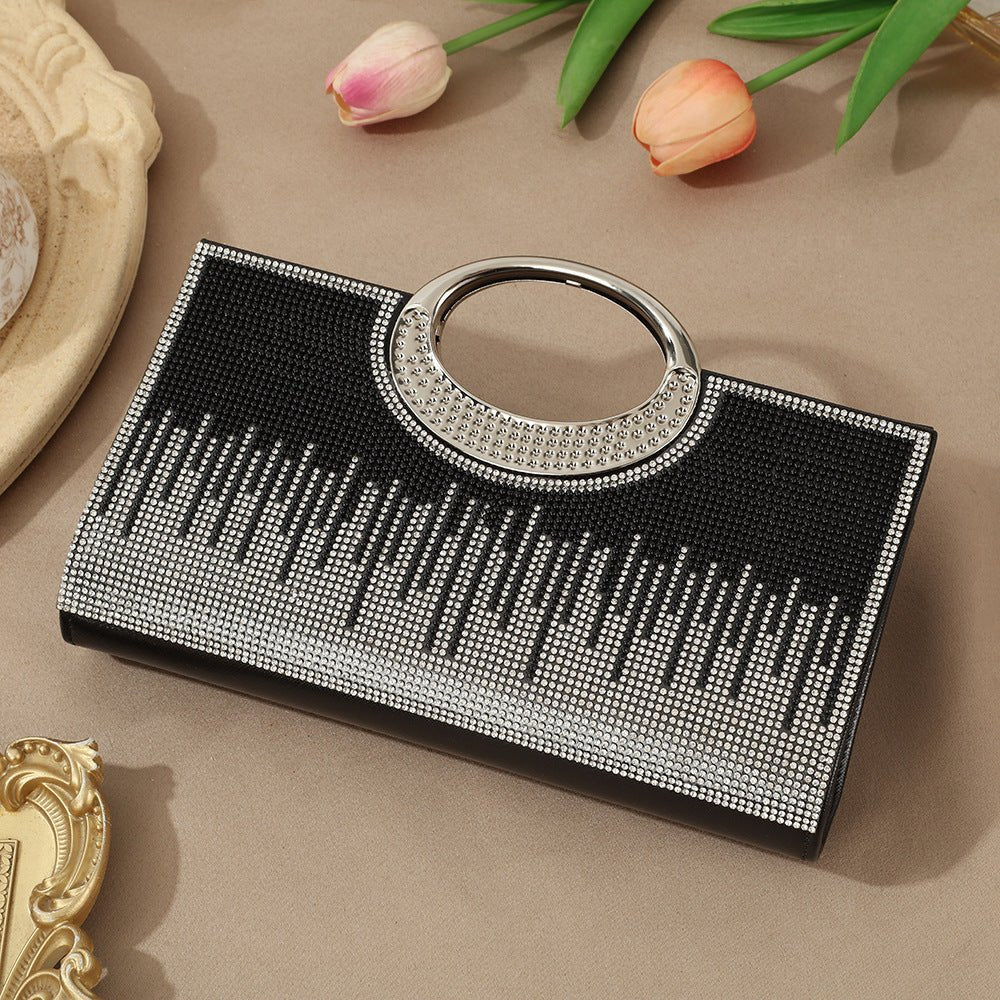 Rhinestone sparkly clutch bag angled to show depth and handle height