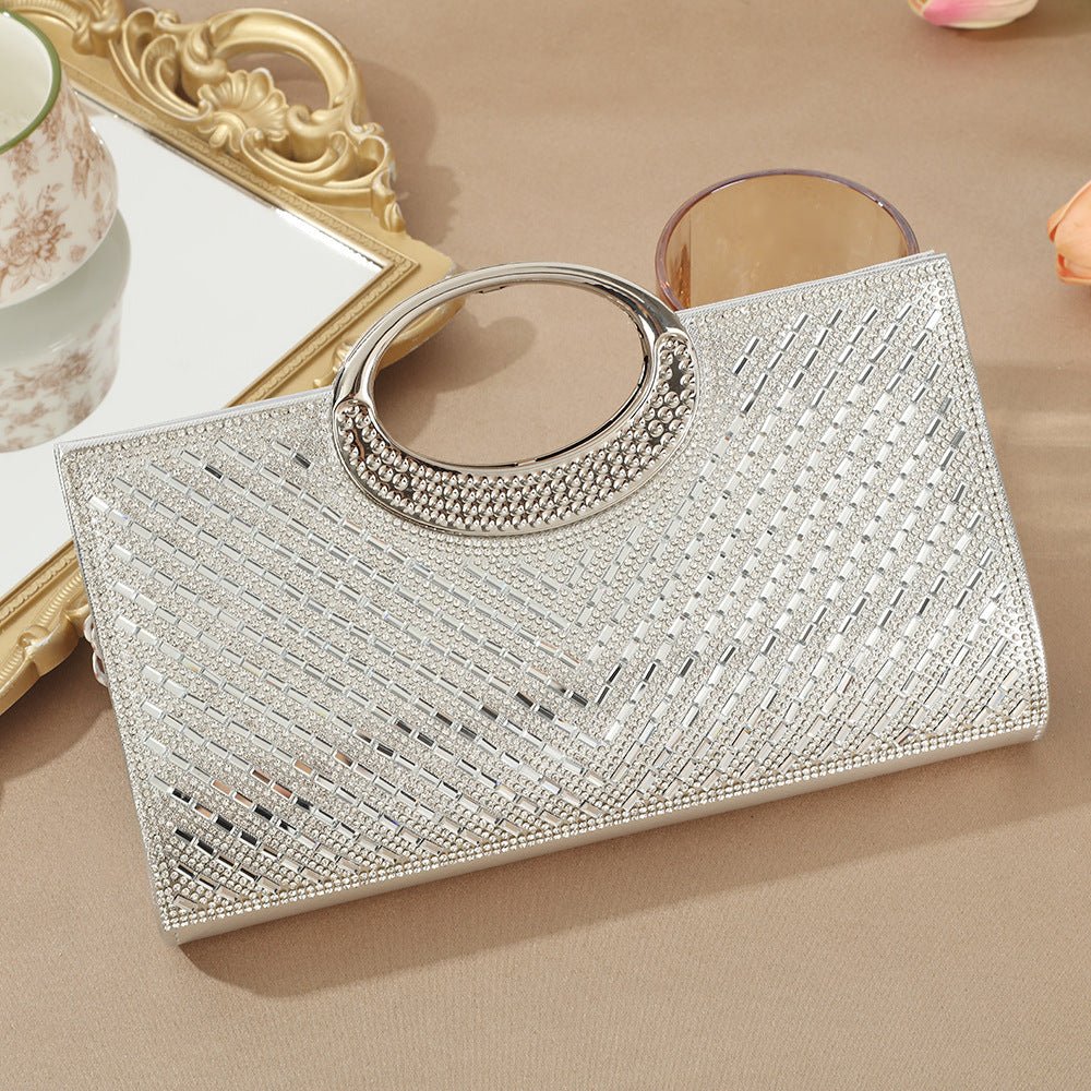 Rhinestone encrusted clutch bag held at arm's length by model in modest dress