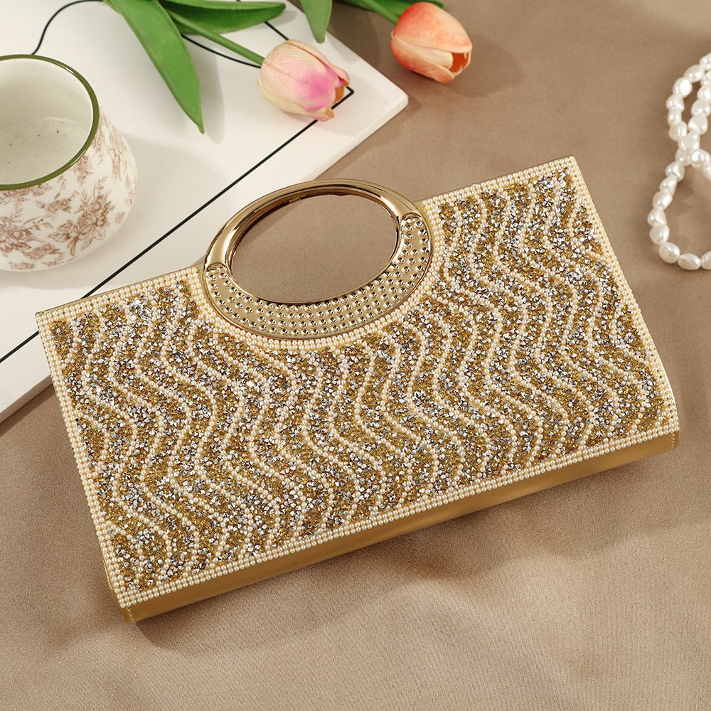 Circular handle detail on sparkly clutch bag showing metal finish lustre
