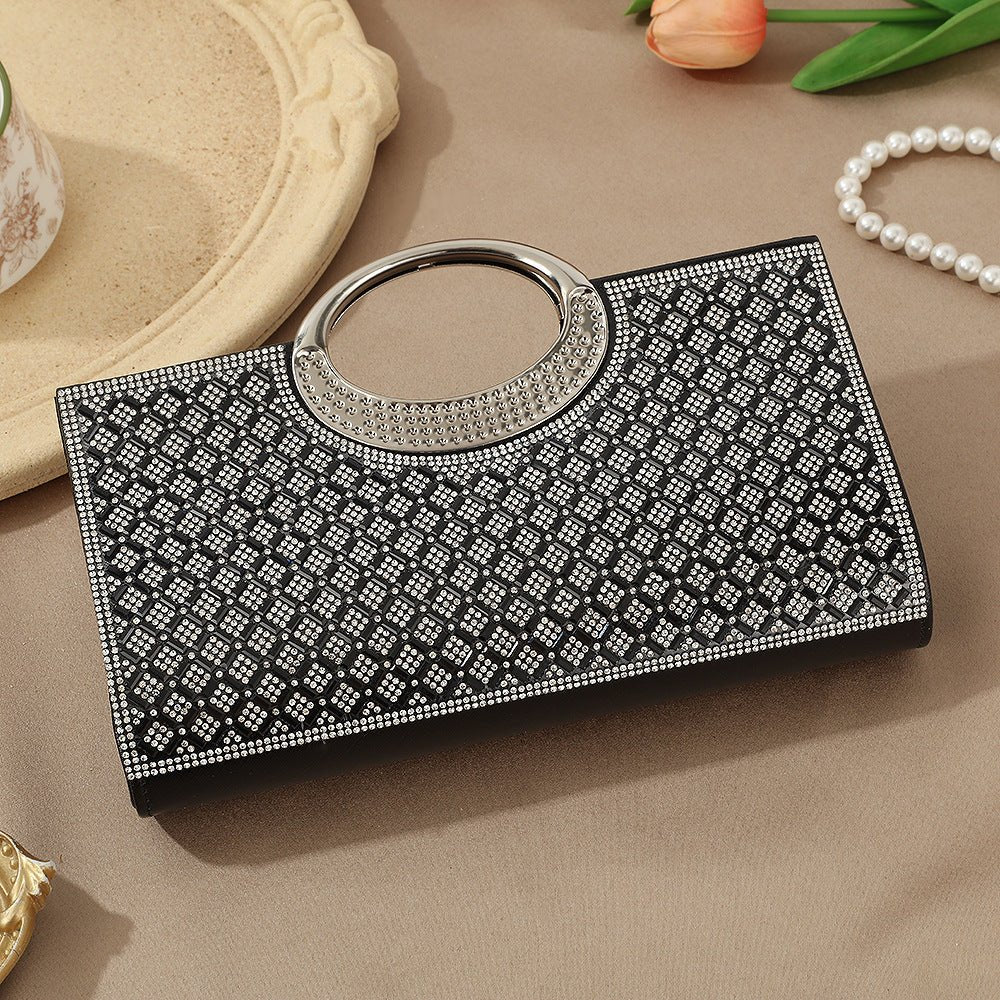 Close-up of clasp and circular handle join on rhinestone clutch bag
