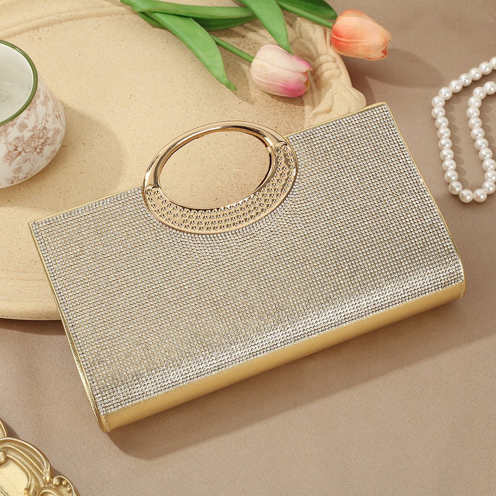 Sparkly evening clutch bag held at wrist level styled with formal wear